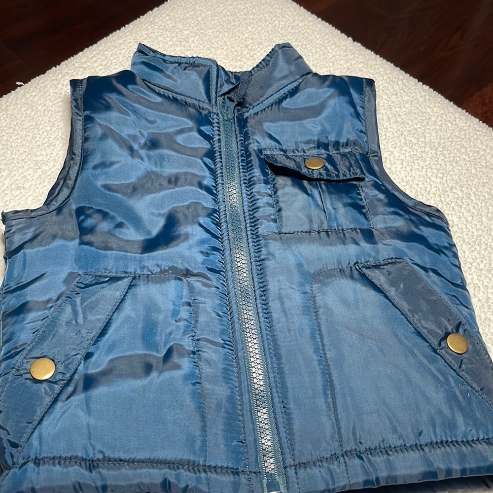Brooklyn Boys blue zip up puffer vest, small snap pocket on left side of vest